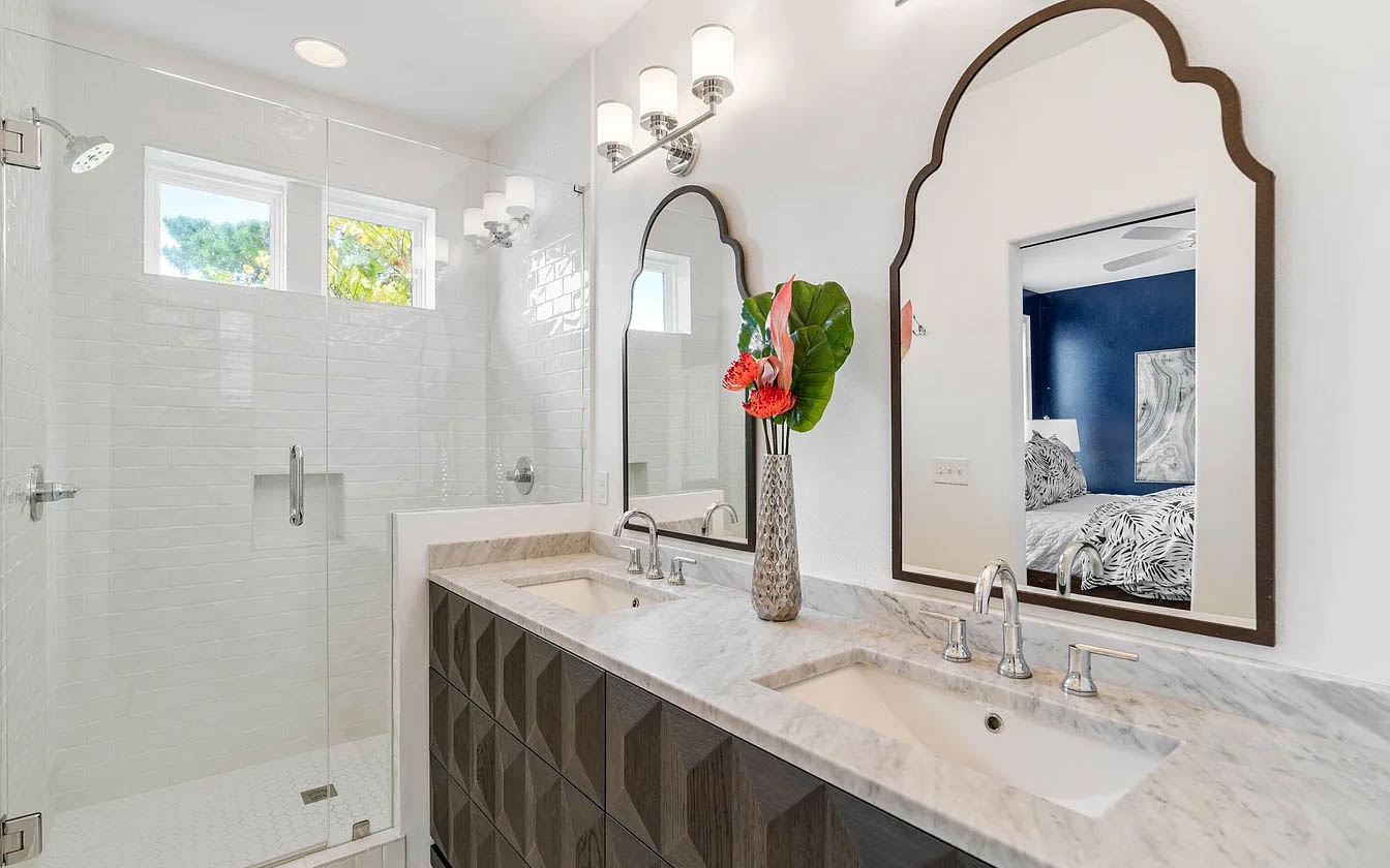 Your elegant master bathroom features a spacious walk-in shower, dual vanities with marble countertops, and stylish lighting for your morning routine.