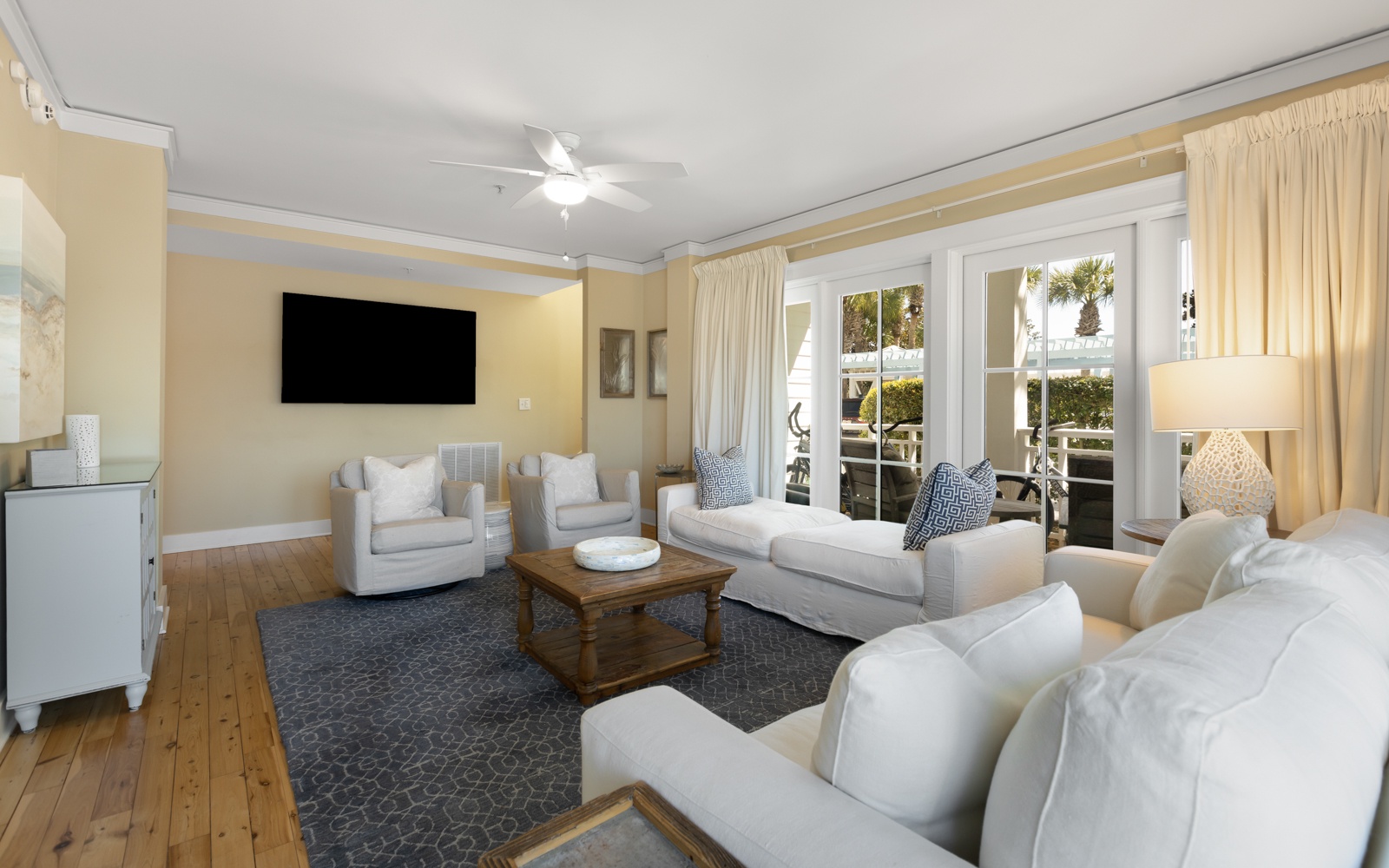 Sink into plush white seating in your bright living space, where warm coastal vibes meet modern comfort for perfect relaxation.