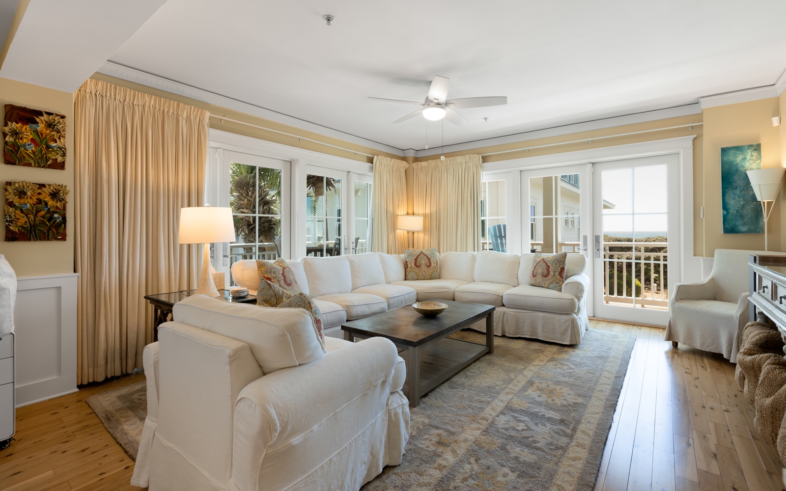 Sink into plush white sofas in your bright living room, where warm lighting and ocean breezes create the perfect retreat.