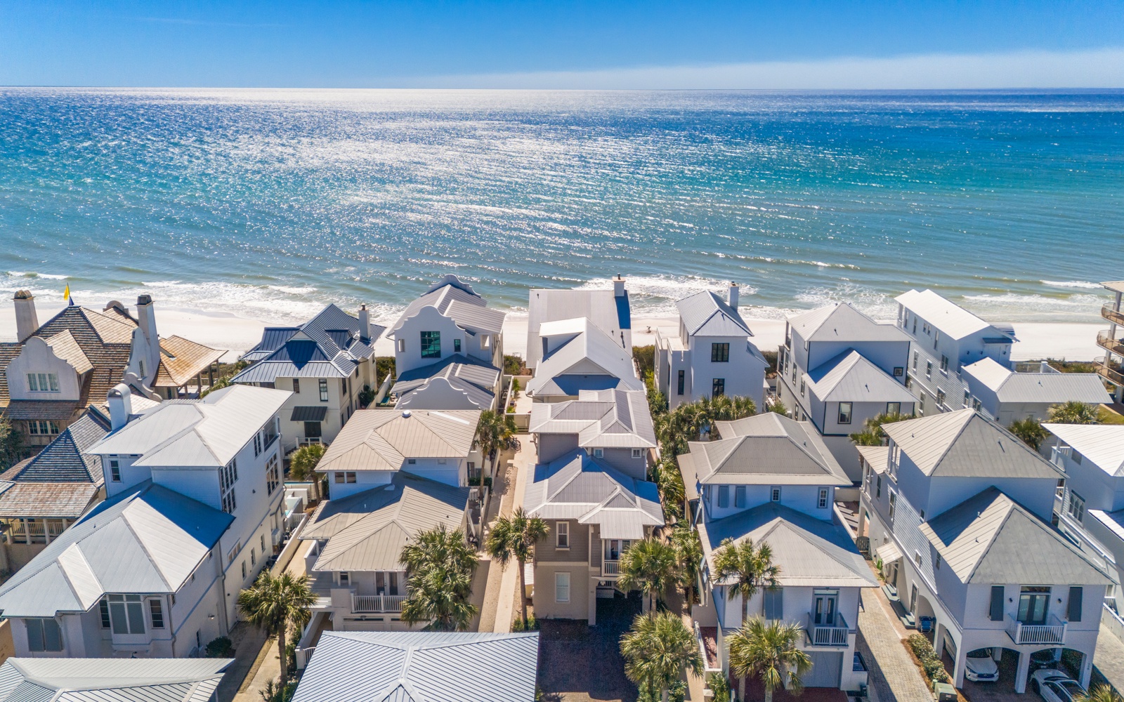 Stunning beachfront community featuring pristine white sand beach and crystal-clear turquoise waters just steps away.