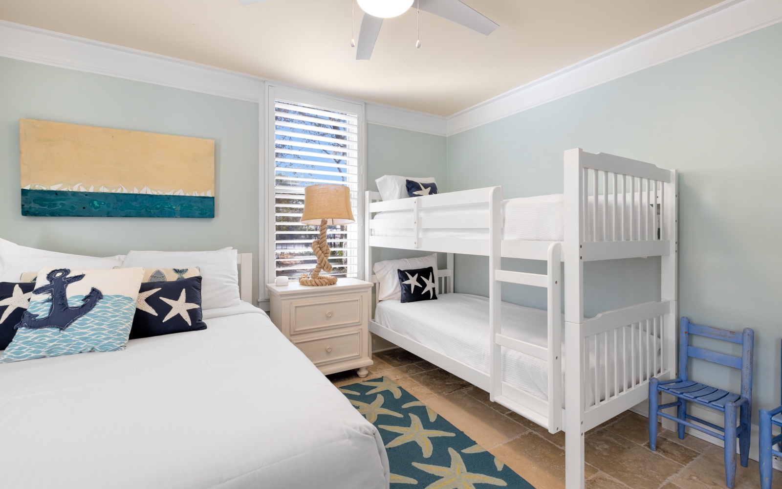 Your family bedroom features nautical-themed décor with bunk beds for the kids and comfortable seating.