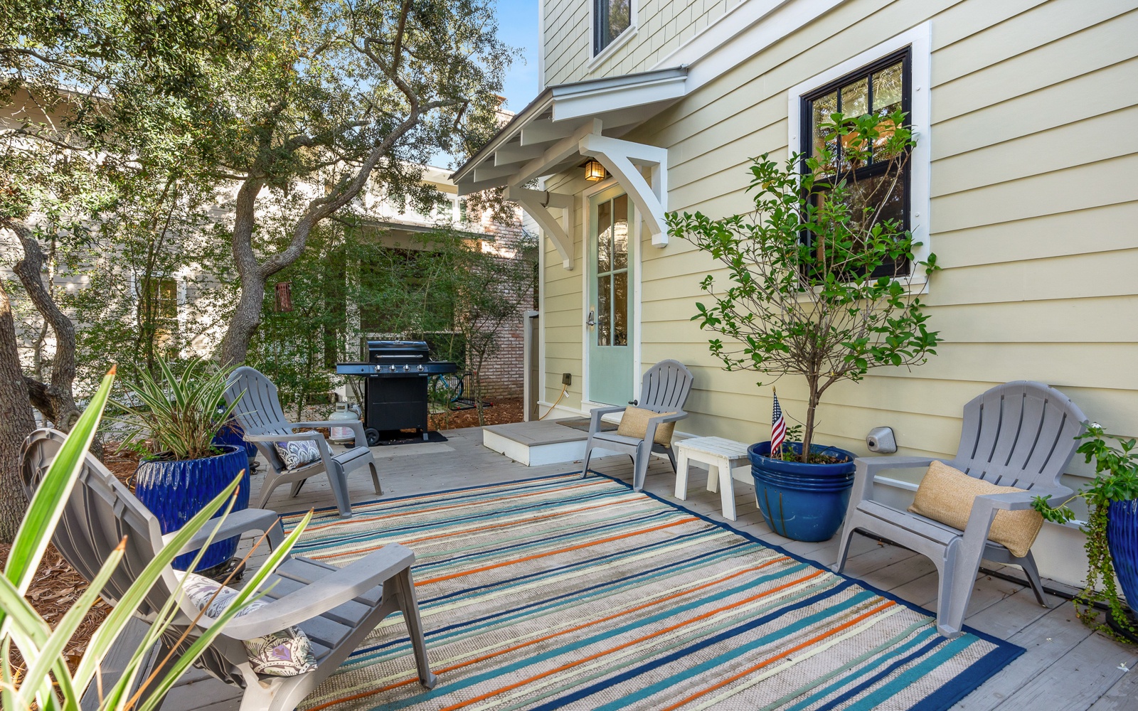 Your private patio beckons with cozy seating and a grill for memorable evenings under the trees.