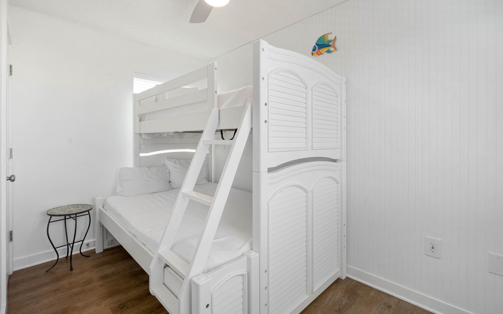 Rest peacefully in your charming bunk bed room, where crisp white linens and coastal cottage details create the perfect retreat.