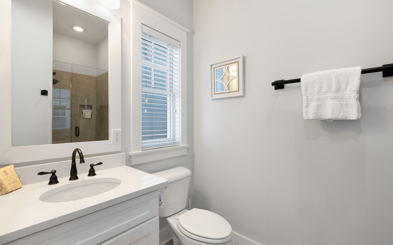 Step into your pristine private bathroom with modern fixtures, soft towels, and natural light streaming through plantation shutters.