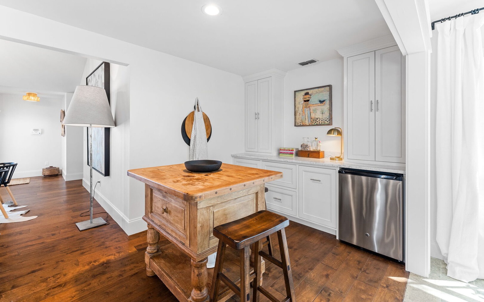 Your stylish kitchen features a rustic butcher block island and modern stainless appliances, creating the perfect blend of charm and functionality.