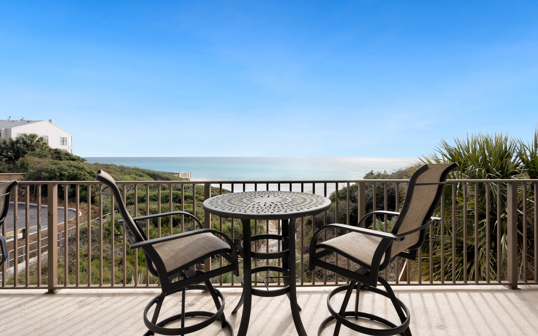 Beautiful ocean views stretch endlessly from this private balcony with comfortable seating for morning coffee or evening relaxation.