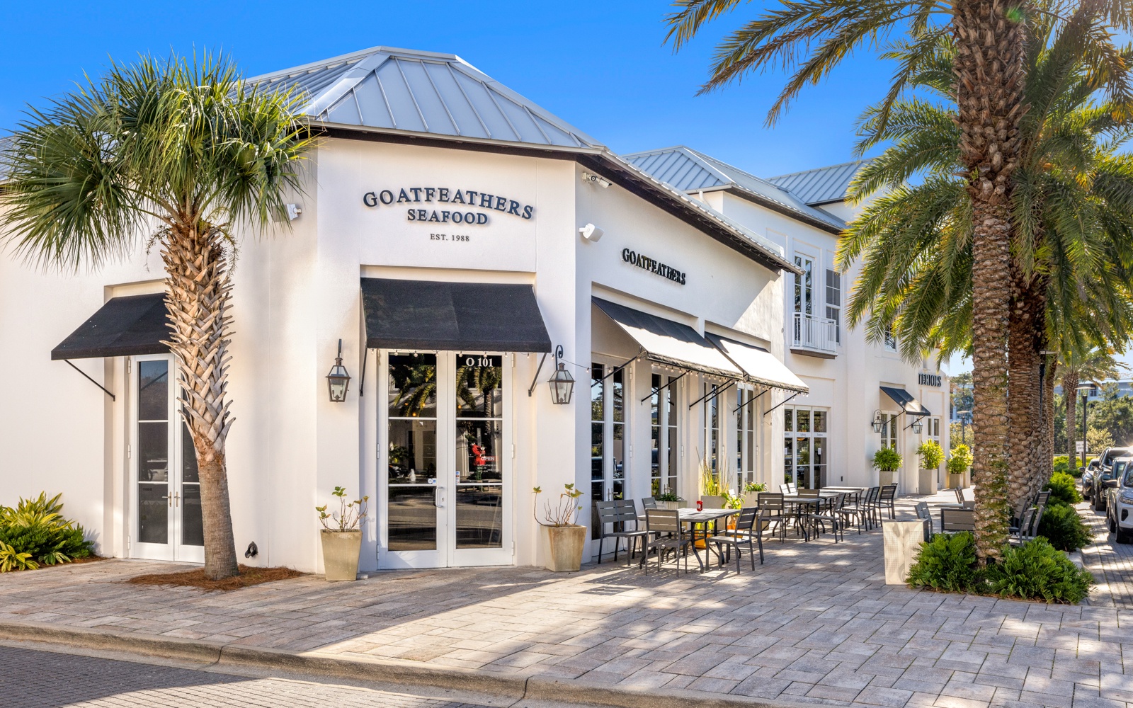 Goatfeathers Seafood restaurant sits conveniently nearby, surrounded by swaying palm trees and outdoor dining under sunny skies.