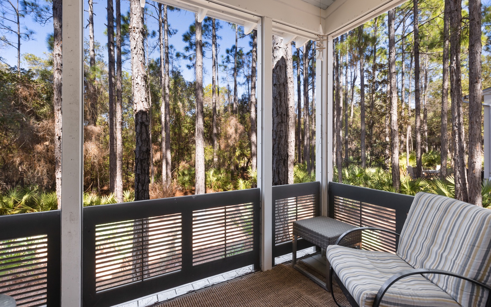Unwind on your private screened porch surrounded by towering trees and tranquil forest views—perfect for morning coffee or peaceful evenings.