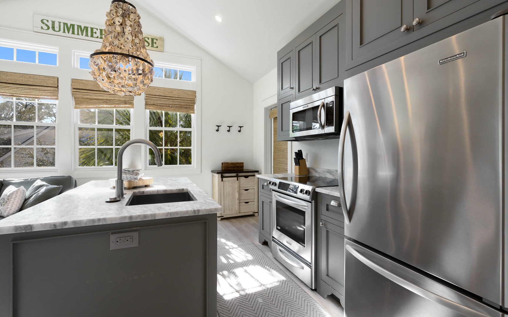 Step into your gourmet kitchen featuring stainless steel appliances, marble countertops, and elegant lighting perfect for creating memorable meals.
