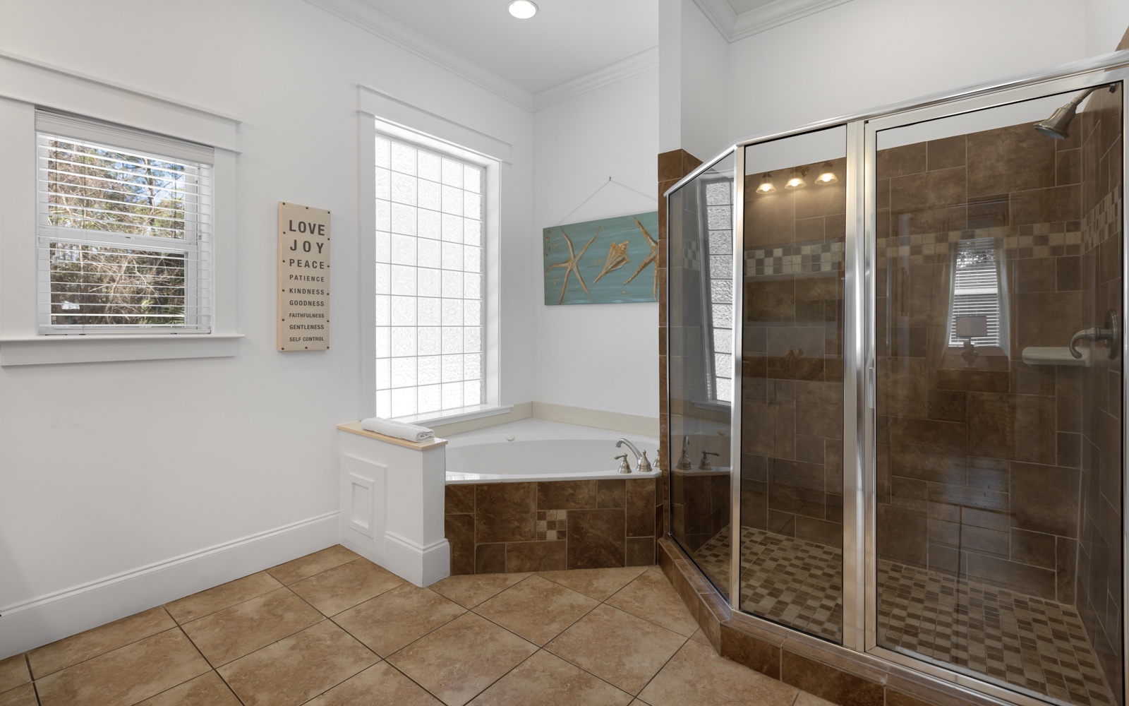 Unwind in your luxurious ensuite with a deep soaking tub and spacious walk-in shower featuring elegant tile work.