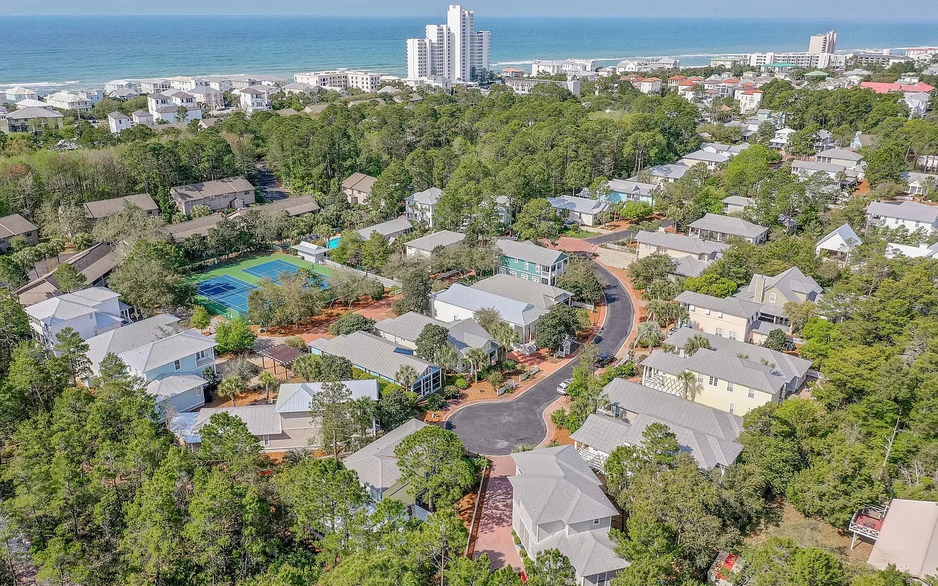 Nestled in a peaceful wooded community just moments from pristine beaches, this coastal retreat offers serene surroundings with beach access.