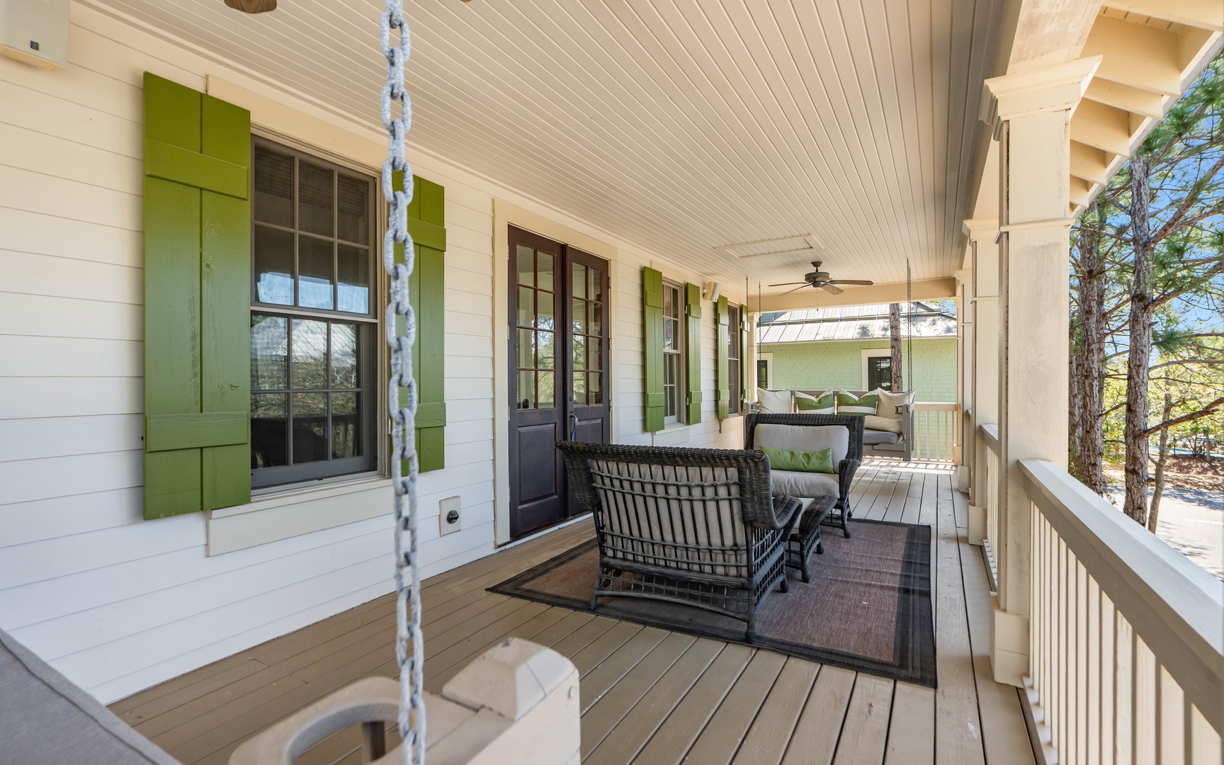 Relax on your charming covered porch with green shutters, where comfortable seating and a swing create the perfect spot for morning coffee or evening conversations.