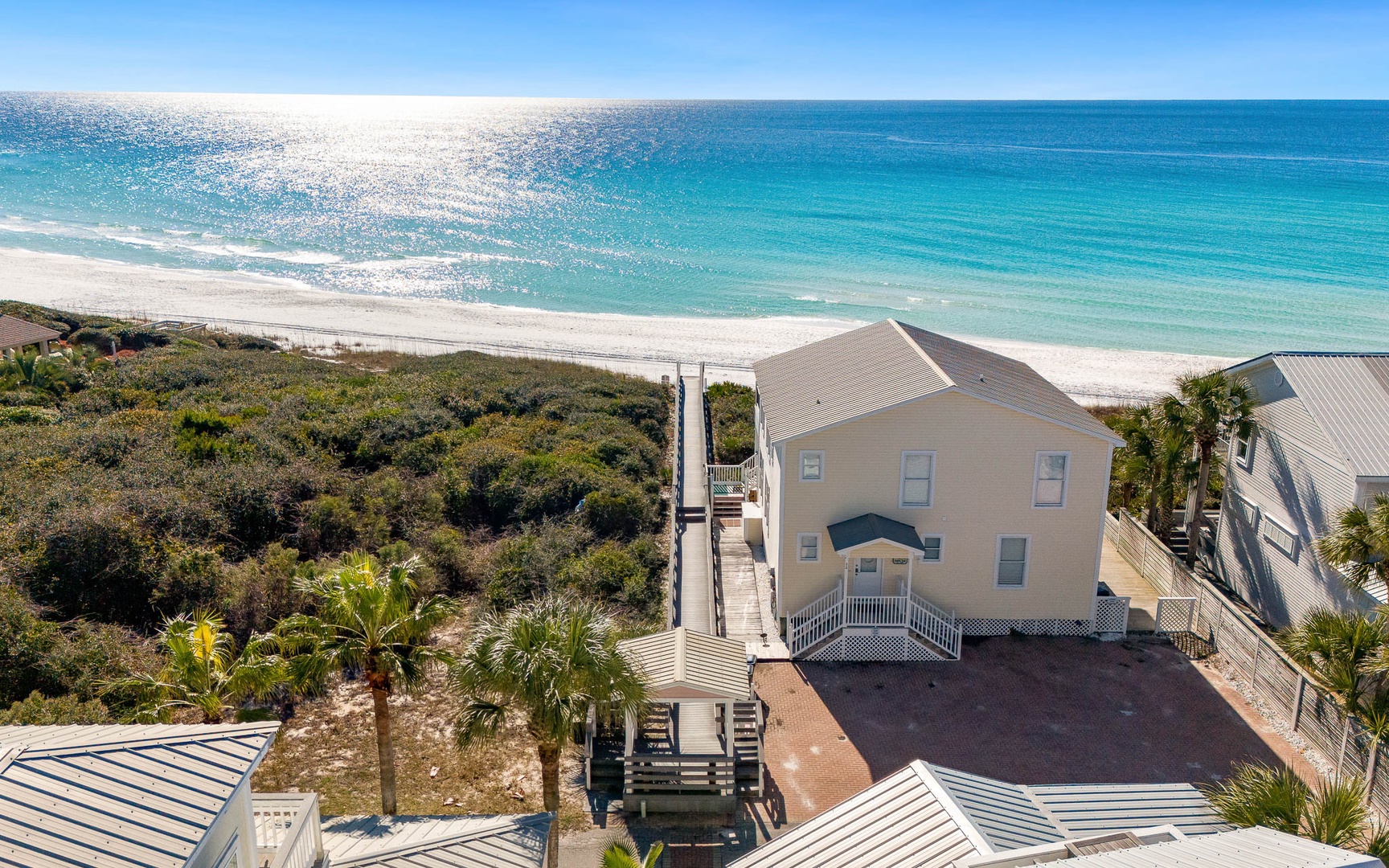 Beachfront property with direct access to pristine white sand and crystal-clear turquoise waters.