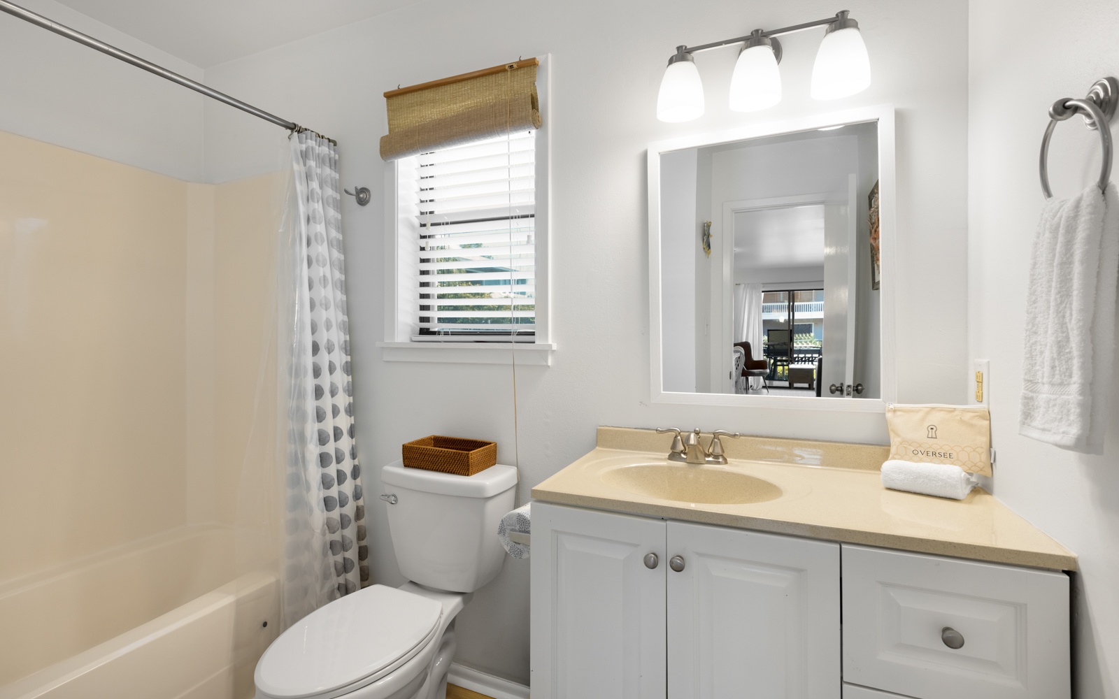Unwind in your private bathroom featuring a spacious tub, well-lit vanity, and fresh towels awaiting your arrival.