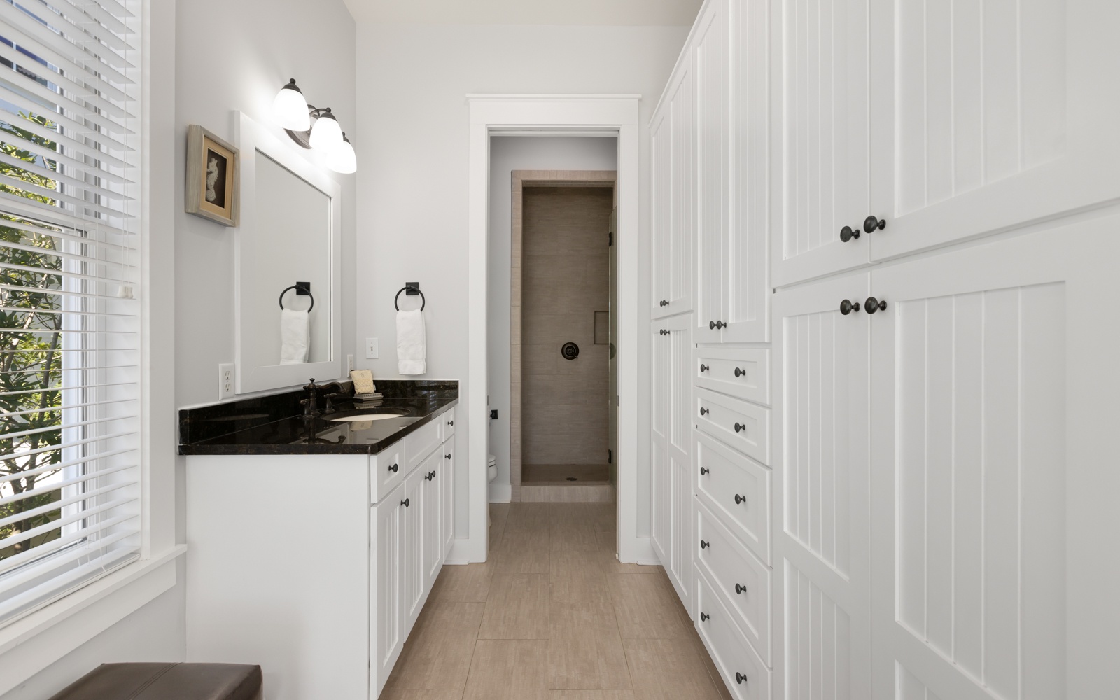 Refresh in your elegant bathroom with dual vanities, black granite counters, and abundant storage for all your essentials.