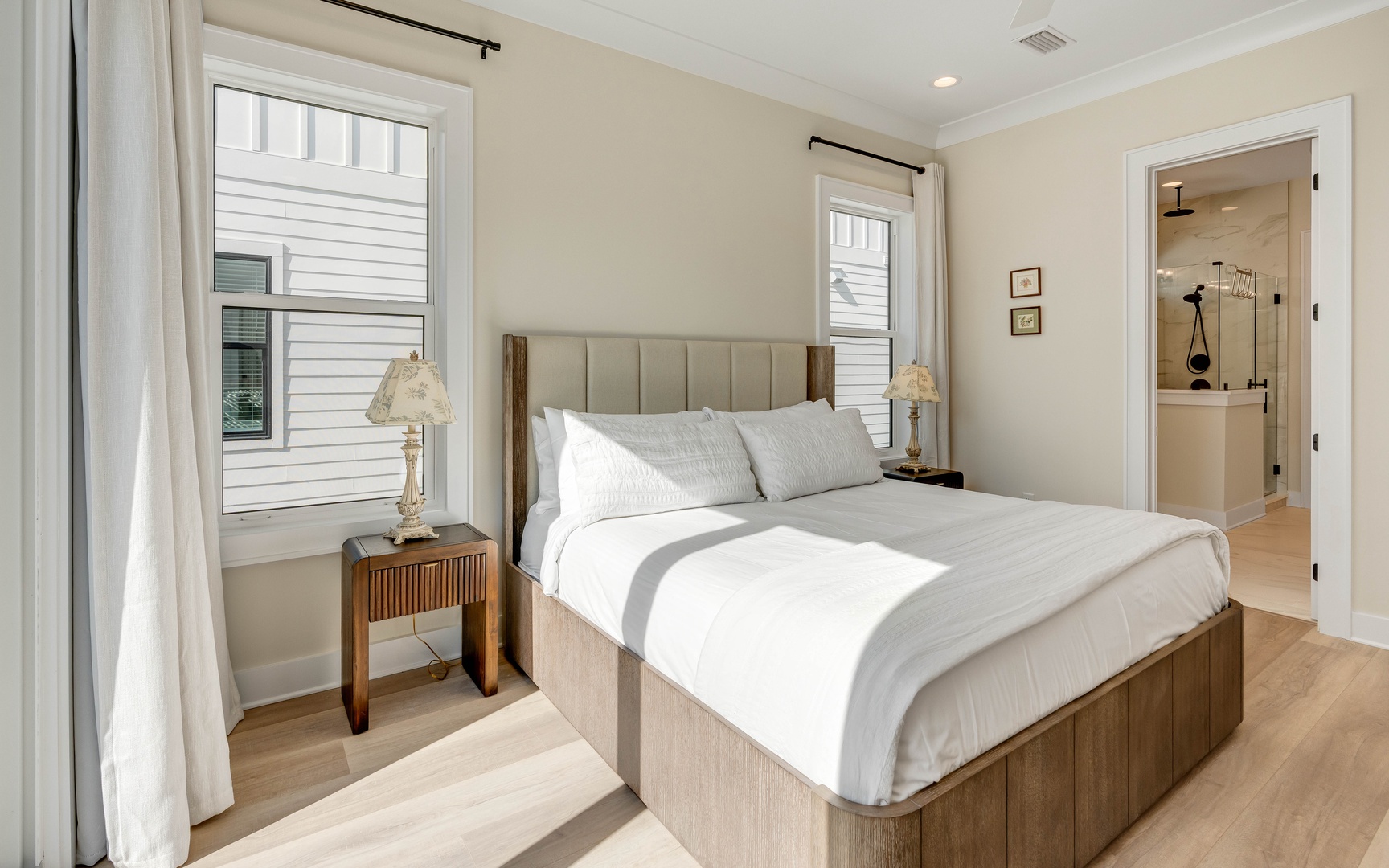 Sink into crisp white linens and wake to natural light in your tranquil bedroom retreat.