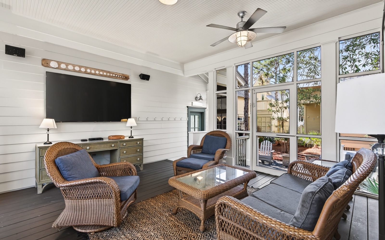 Relax in your private screened porch with comfortable wicker seating, perfect for morning coffee or evening conversations.