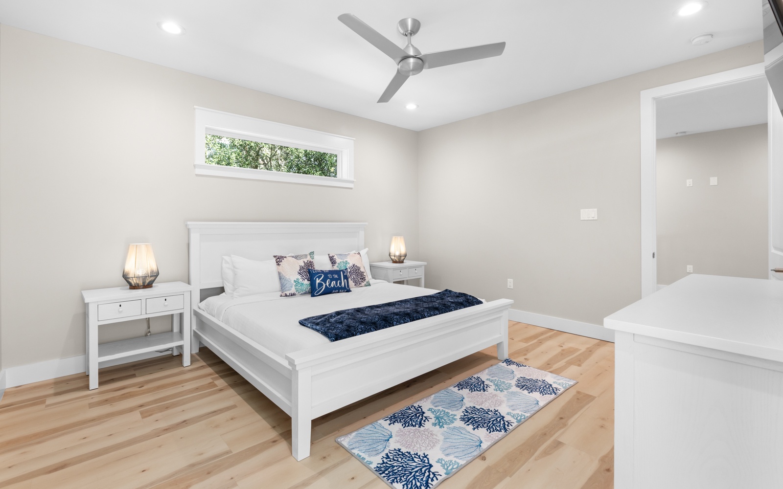 Rest peacefully in your bright, airy bedroom with crisp white linens and coastal touches that invite sweet dreams.