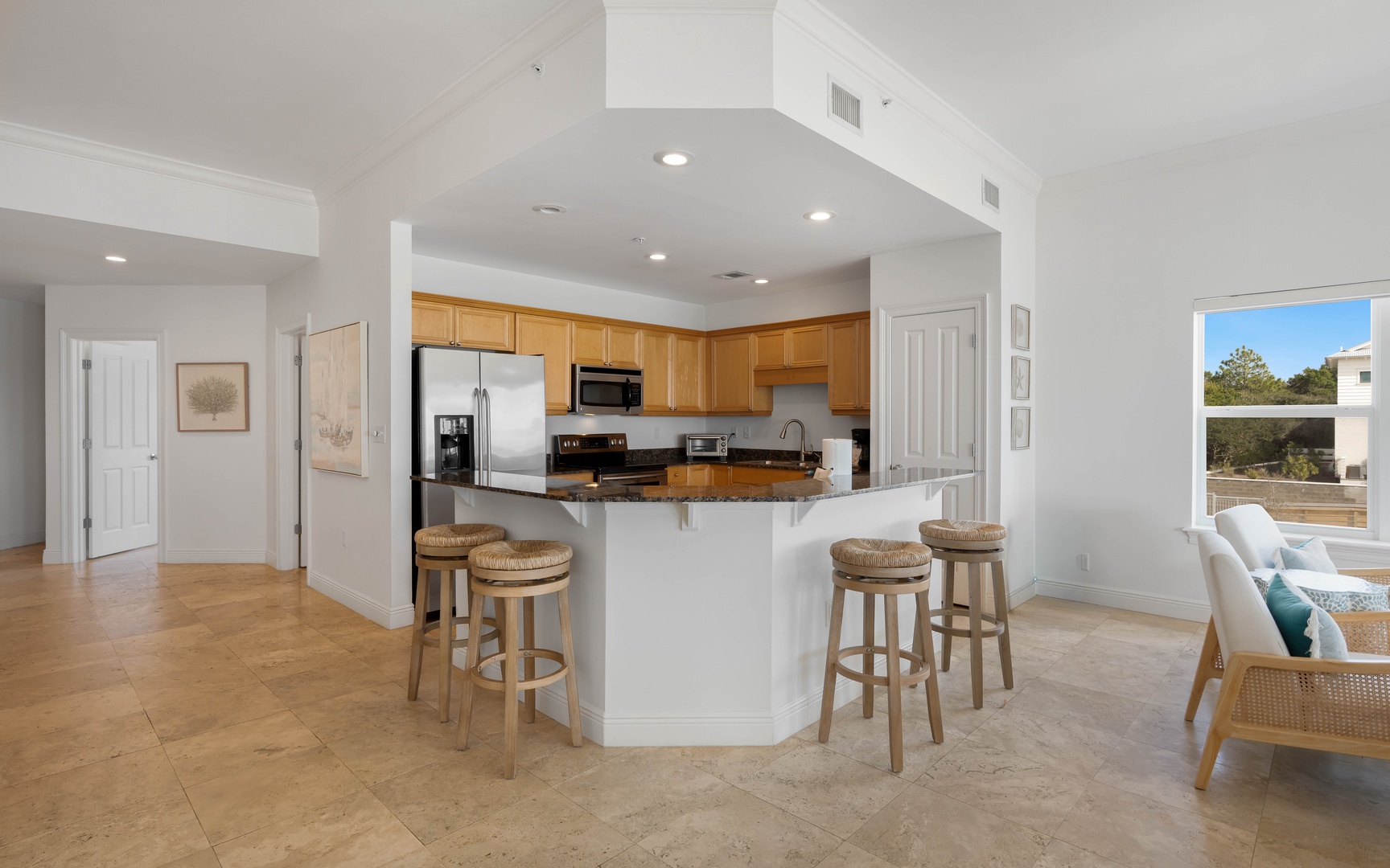 Gather around your spacious kitchen island where morning coffee and evening conversations flow naturally in this bright, open space.