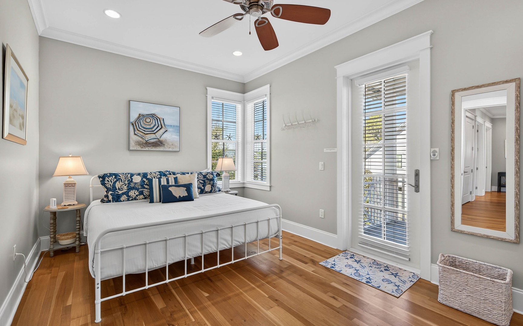 Drift off to peaceful sleep in this serene bedroom with coastal charm and natural light streaming through.