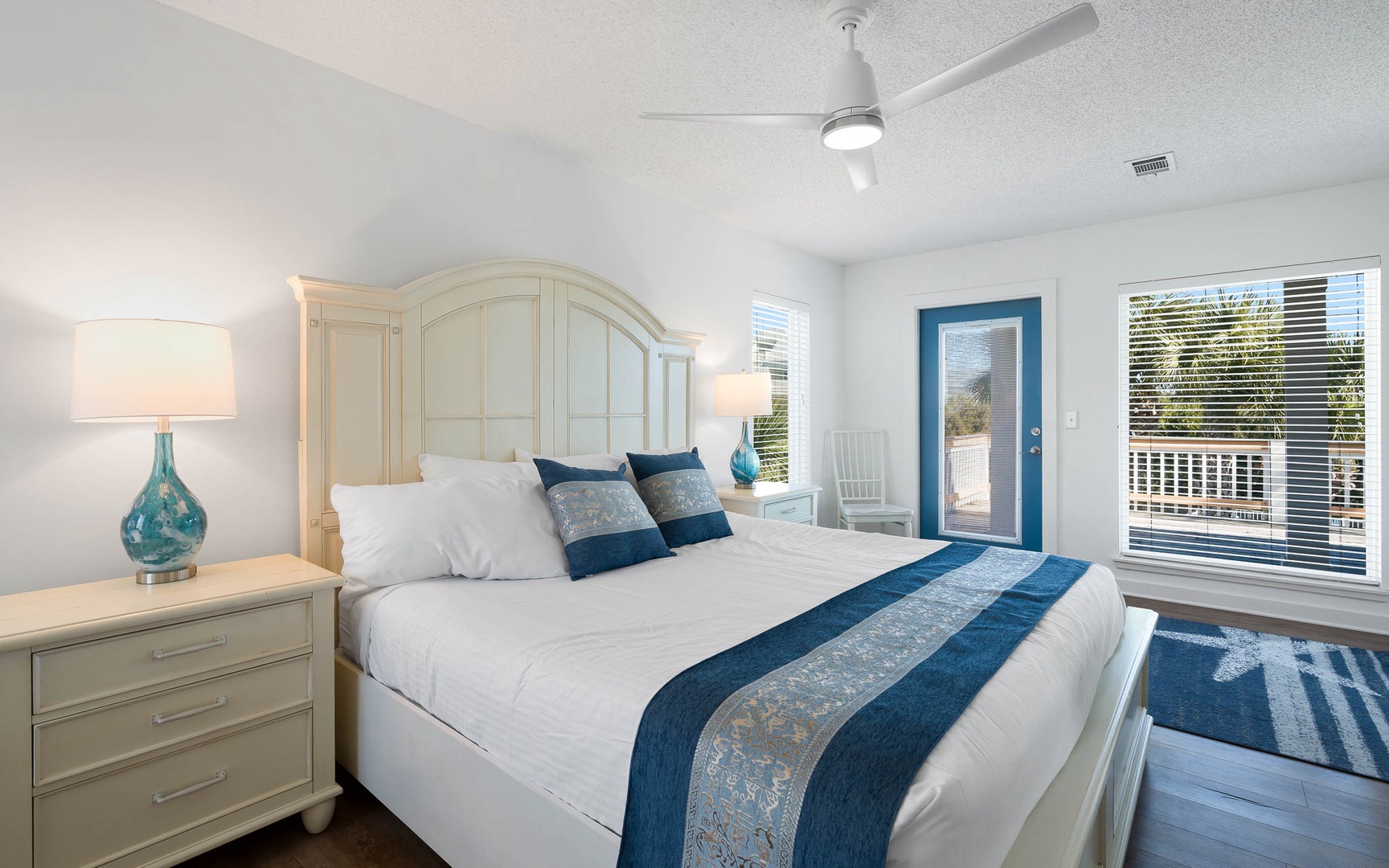 Drift off in this serene bedroom with coastal blues, elegant furnishings, and your private balcony for morning coffee moments.