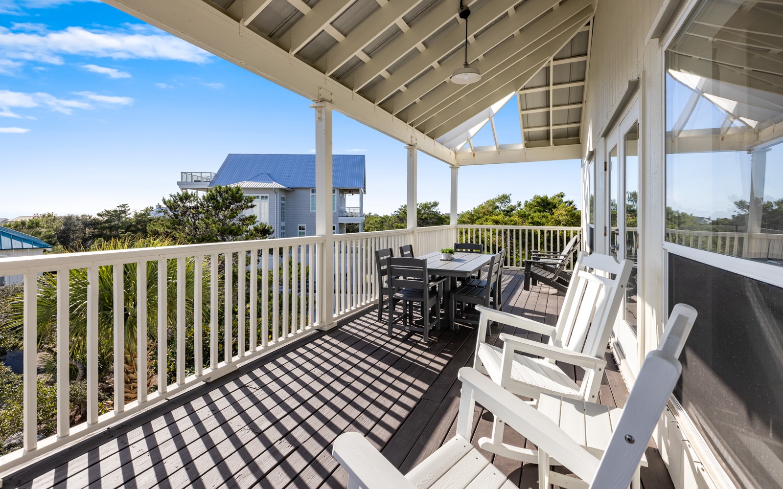 Your private covered deck awaits with comfortable seating and dining space, perfect for morning coffee or sunset dinners.