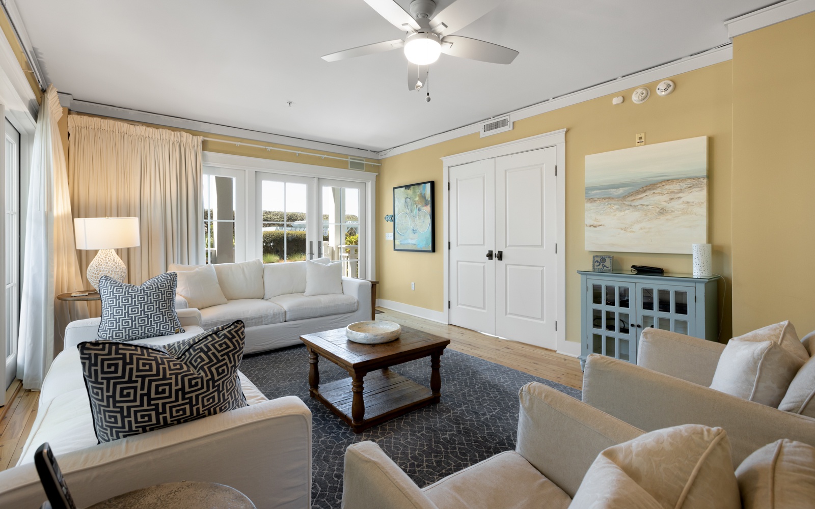 Unwind in this sun-drenched living room where plush sofas invite you to relax while gentle coastal breezes flow through.
