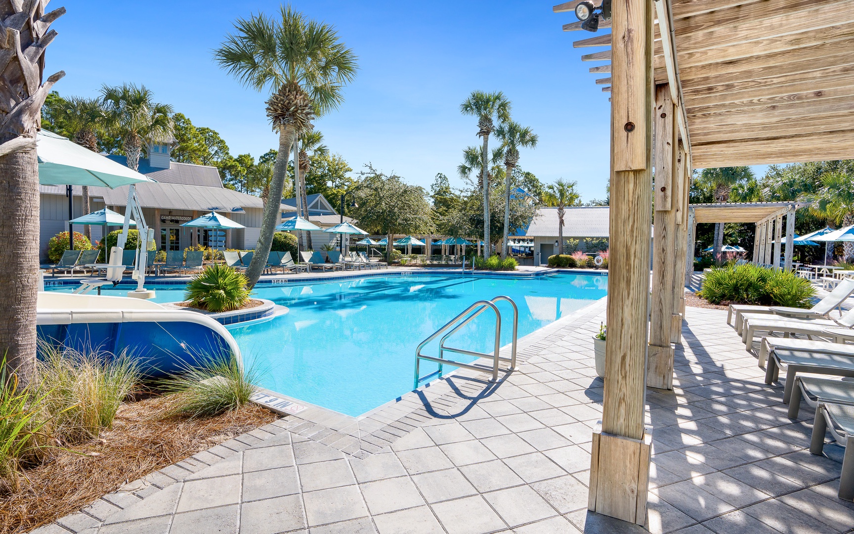 Dive into crystal-clear waters surrounded by swaying palms and comfortable loungers—your perfect poolside retreat awaits.