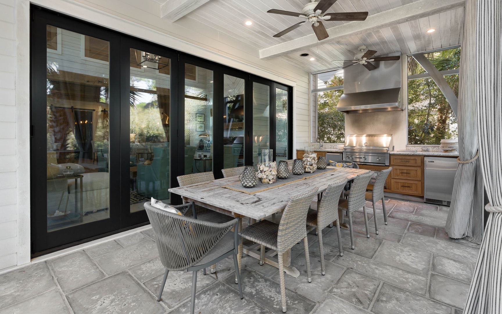 Gather around your elegant outdoor dining table for memorable meals under the covered terrace, with a full kitchen just steps away.