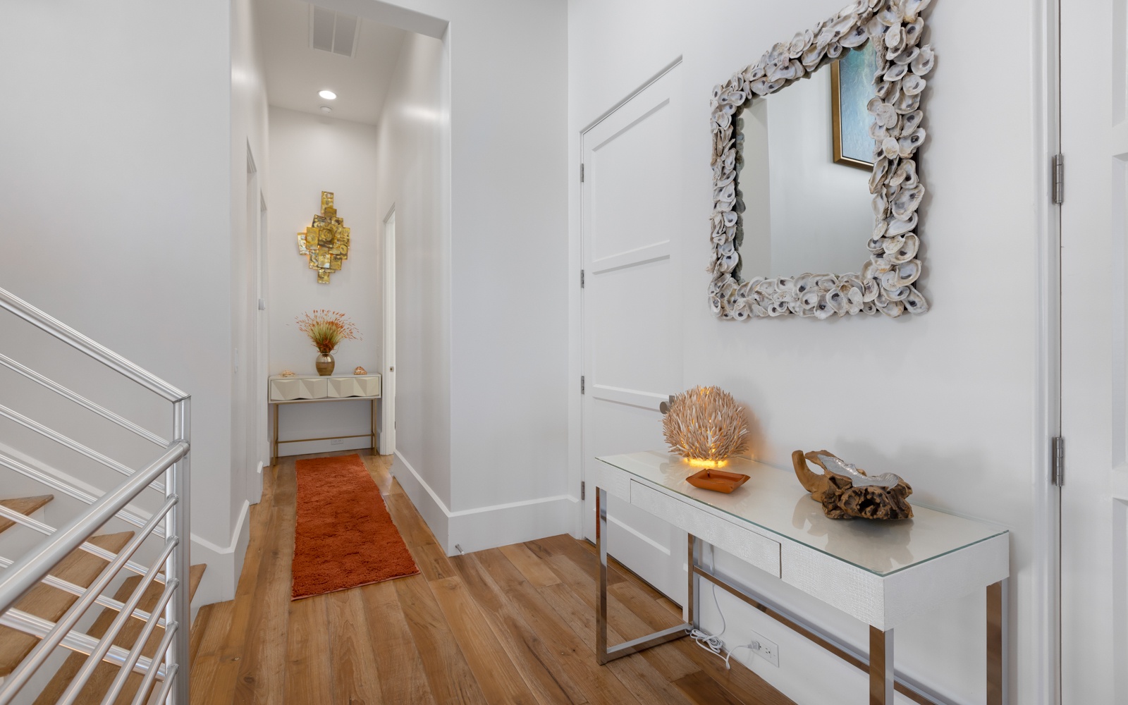 Step into your elegant entryway featuring gleaming hardwood floors, artistic touches, and coastal décor that sets a sophisticated tone.