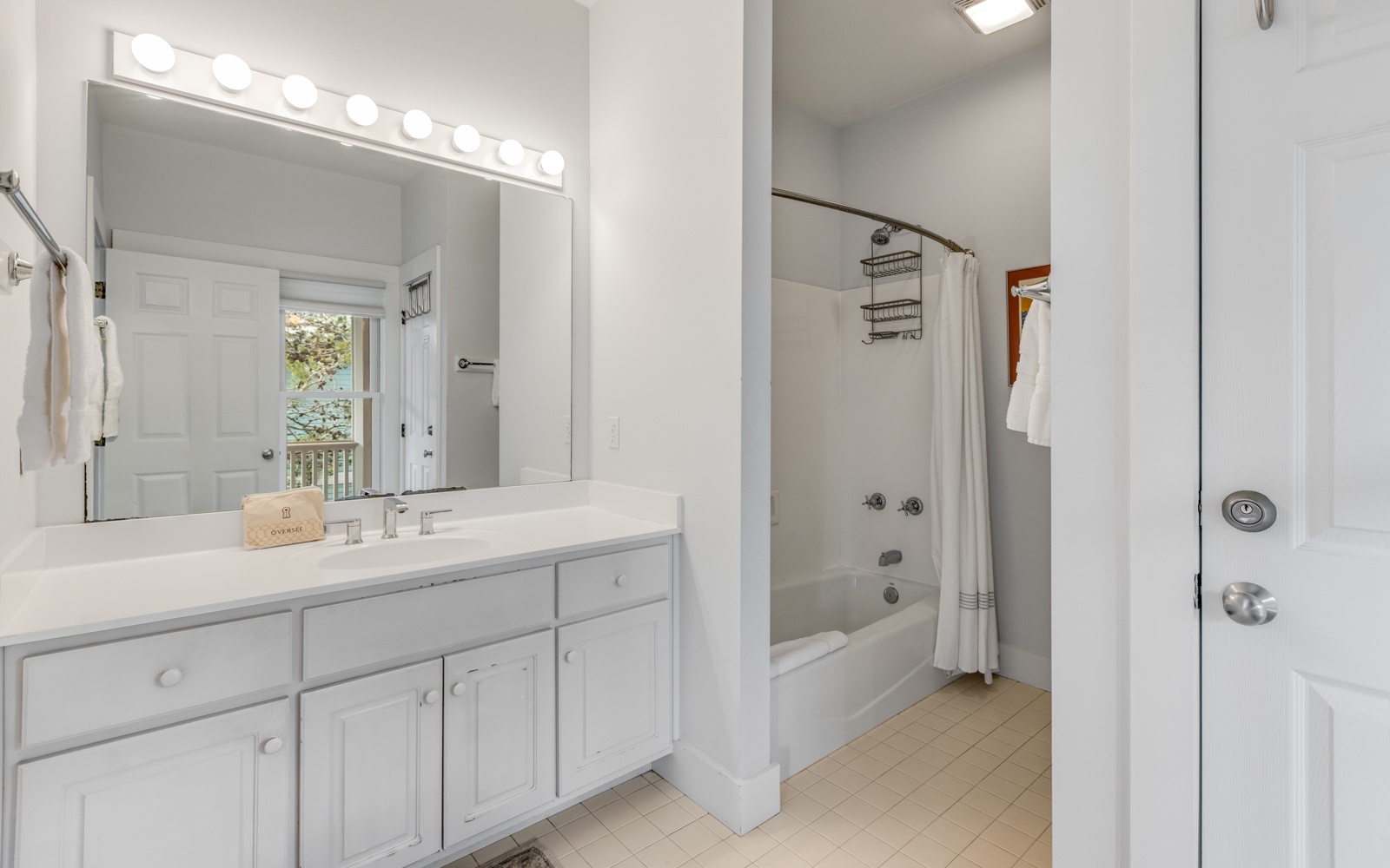Your bright bathroom features a spacious vanity with Hollywood-style lighting, perfect for getting ready each morning.