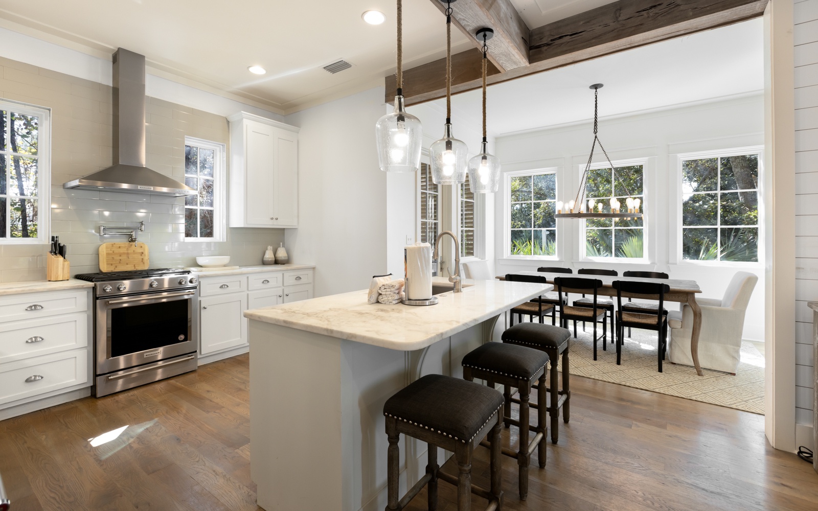 Your dream kitchen awaits with gleaming white cabinets, marble island, and professional appliances perfect for cooking memorable meals together.