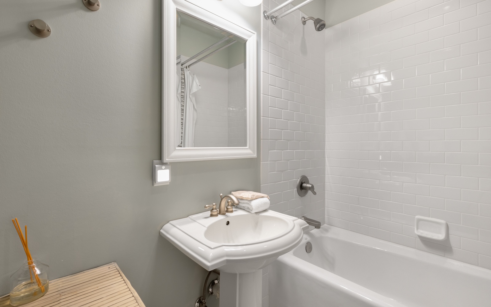 Your private bathroom features a relaxing tub-shower combo with fresh white subway tiles and modern fixtures for your comfort.