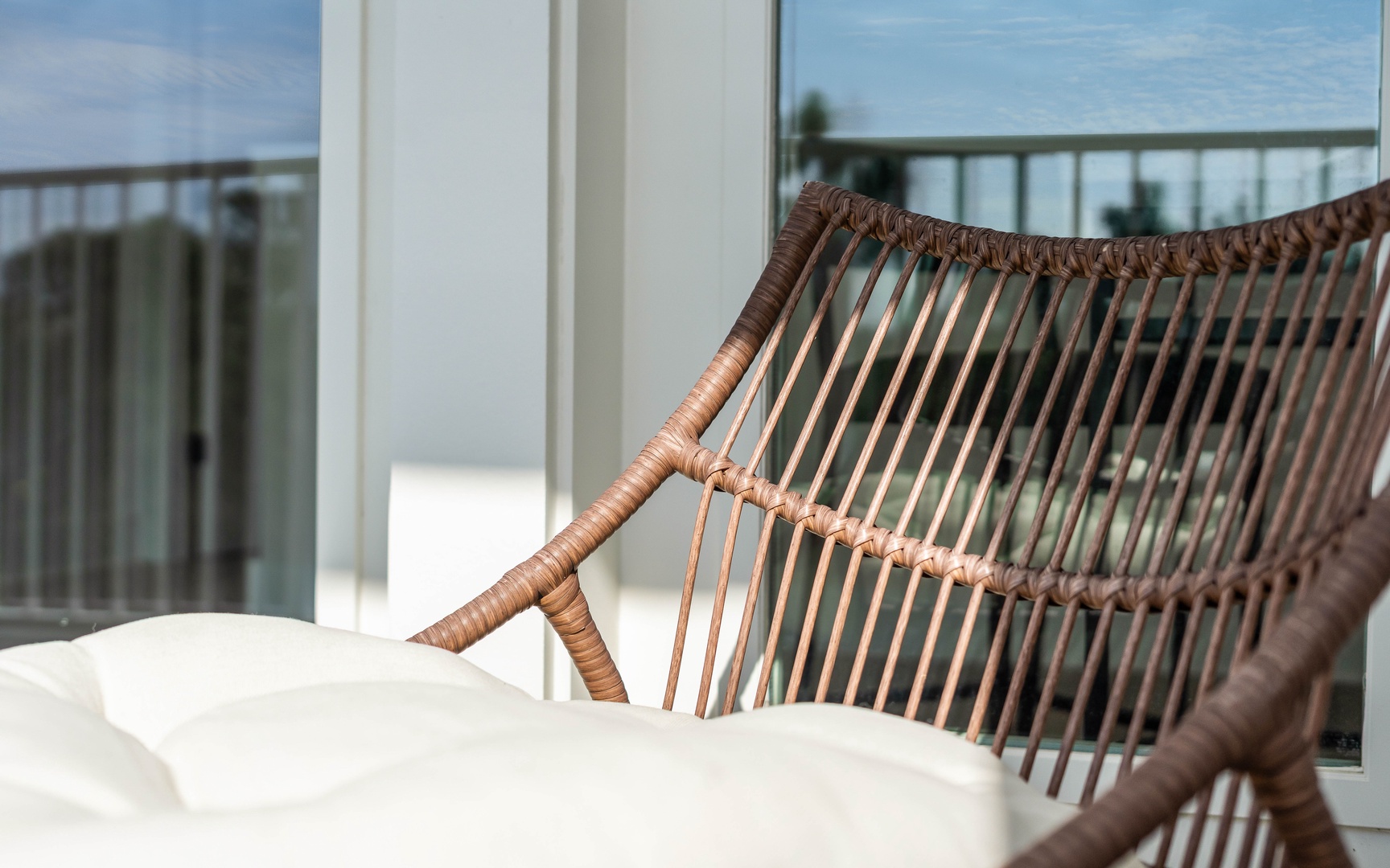 Sink into your wicker chair and soak up stunning balcony views—the perfect spot for morning coffee or sunset relaxation.