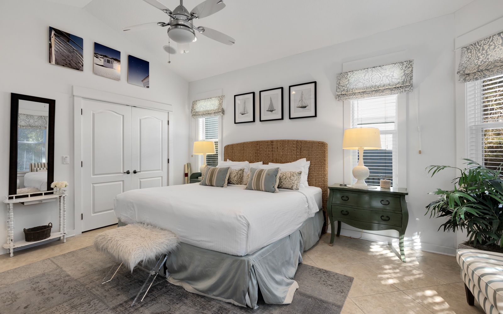Unwind in your serene bedroom sanctuary featuring a plush king bed, woven headboard, and elegant nautical touches that whisper coastal tranquility.
