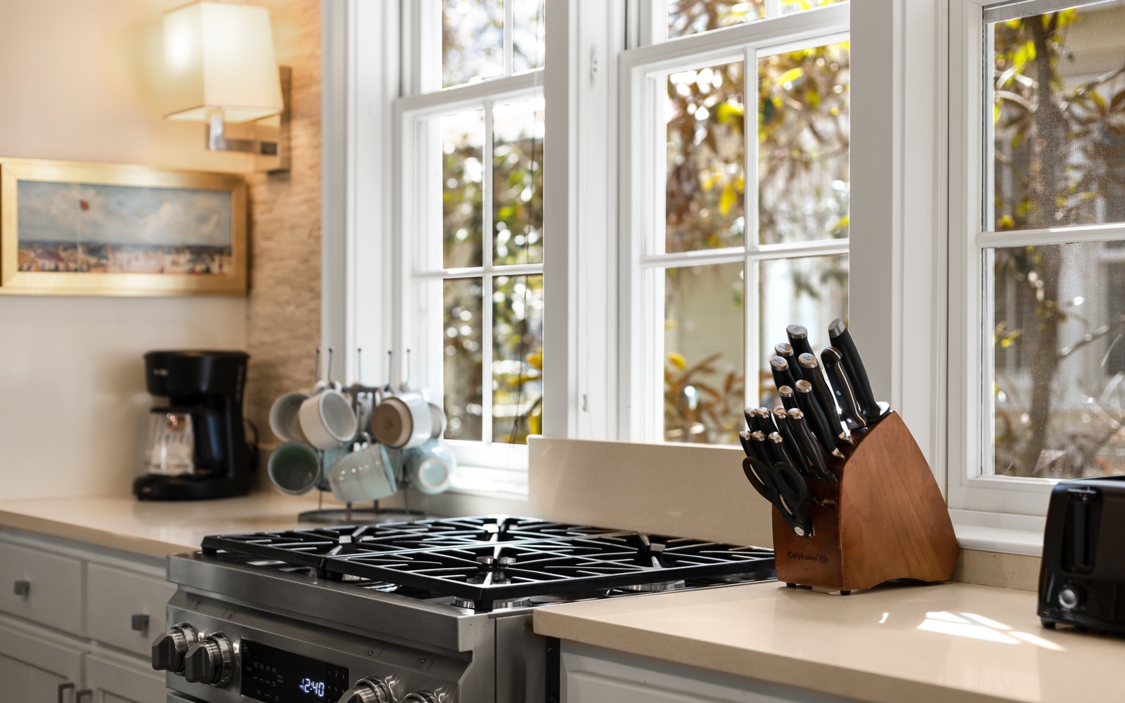 Your fully-equipped kitchen invites culinary adventures with professional-grade appliances, quality knife set, and sunlit workspace overlooking peaceful garden views.