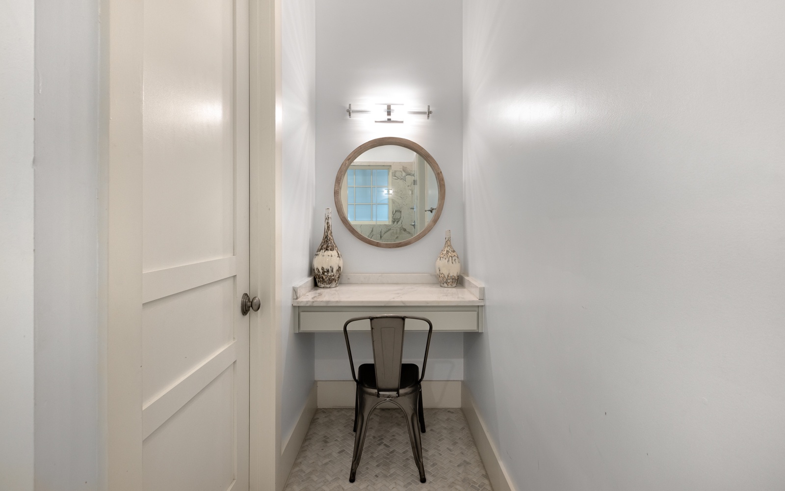 Your private vanity nook features elegant lighting and a cozy chair—perfect for morning routines or evening touch-ups.