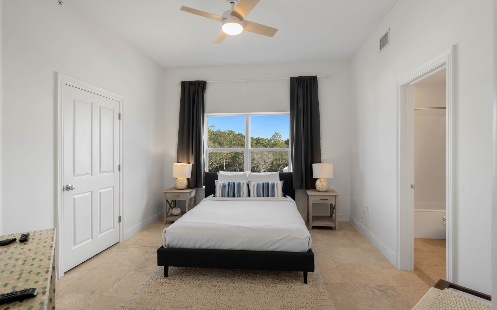 Rest peacefully in your bright bedroom with crisp linens and garden views through oversized windows.