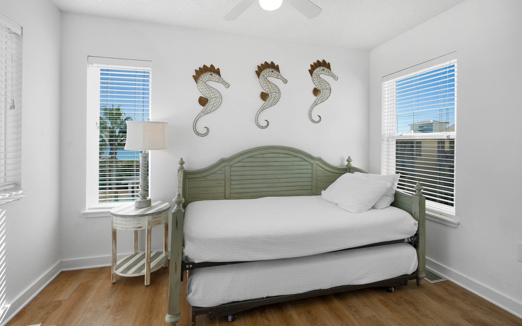Drift off in your coastal-themed bedroom with charming seahorse art and city views from both windows.