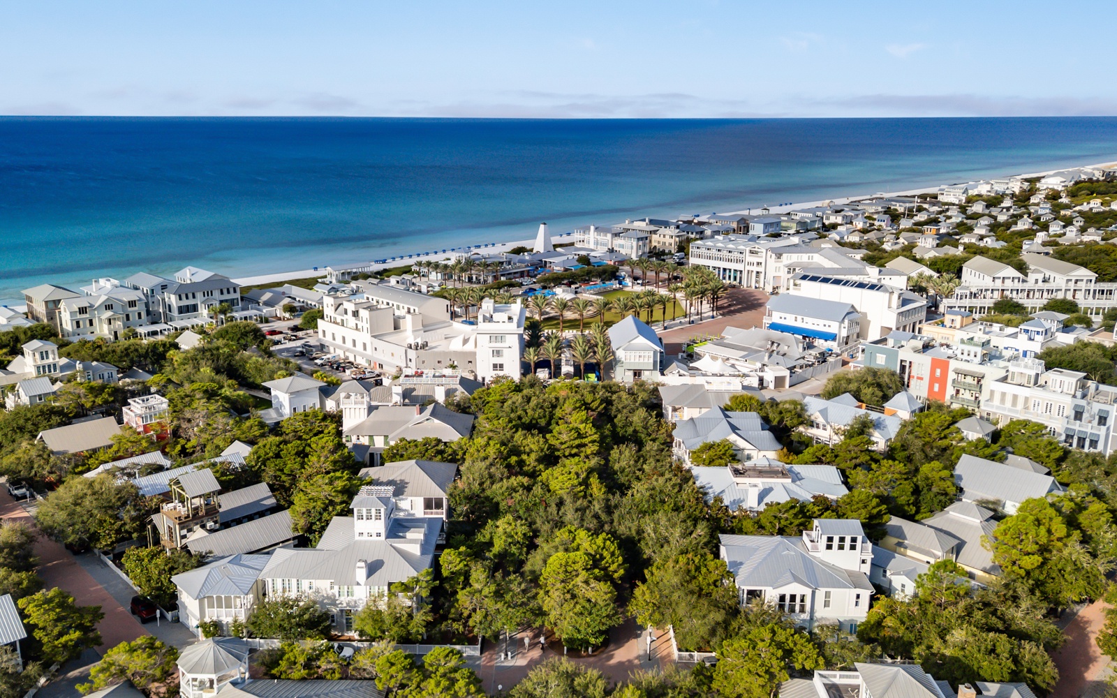 Charming coastal community with white-sand beaches and turquoise waters, featuring tree-lined streets and distinctive architecture near the Gulf Coast.