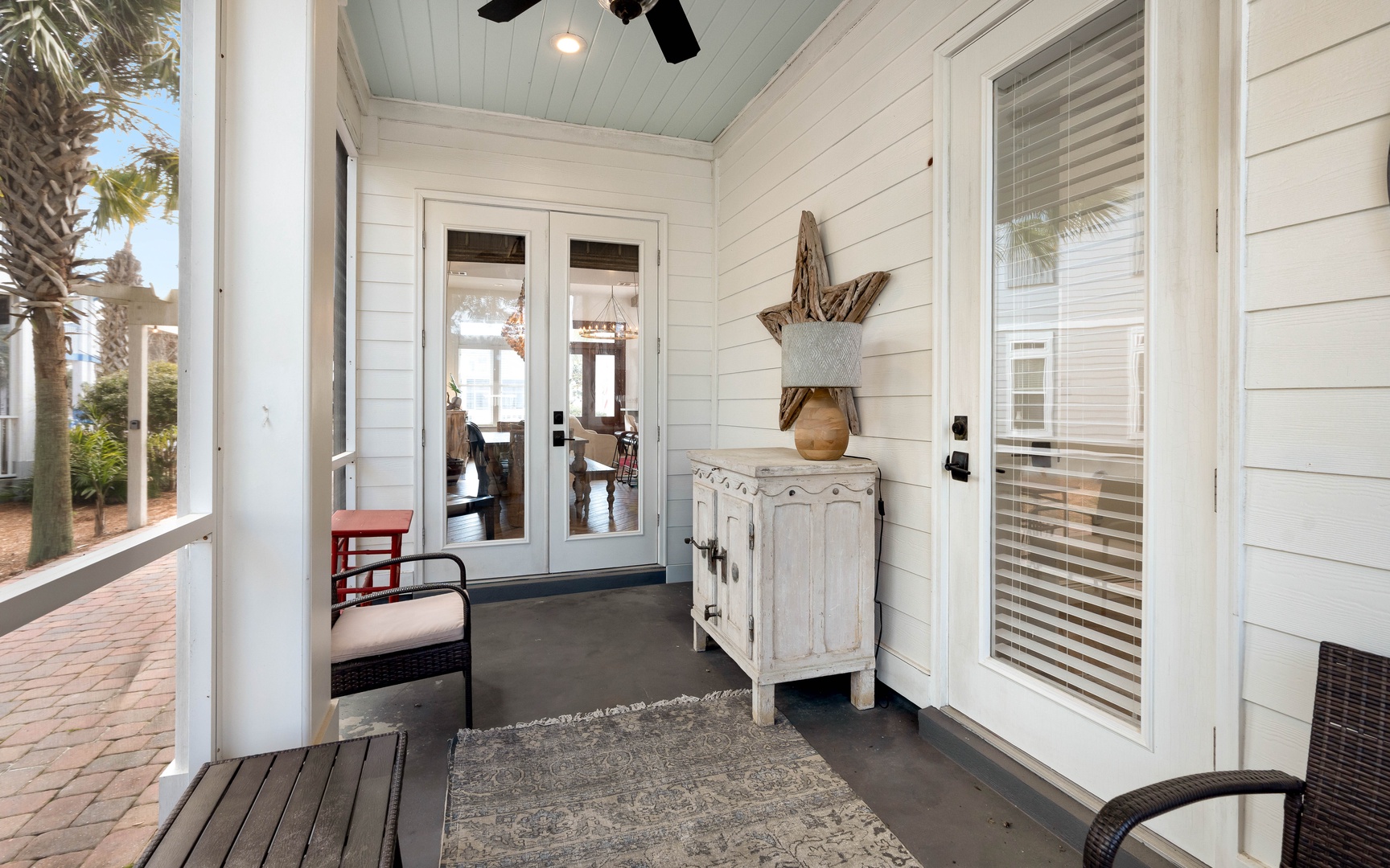 Step onto your private covered porch with coastal charm—the perfect spot to unwind with morning coffee before exploring the day ahead.