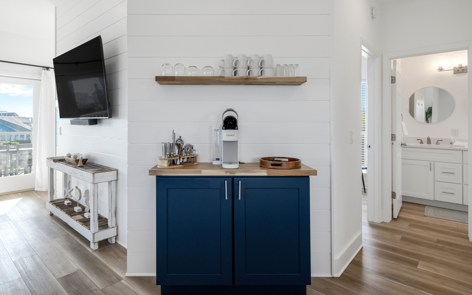 Your stylish kitchenette features navy cabinets, wood counters, and modern appliances, perfect for morning coffee or light meals.