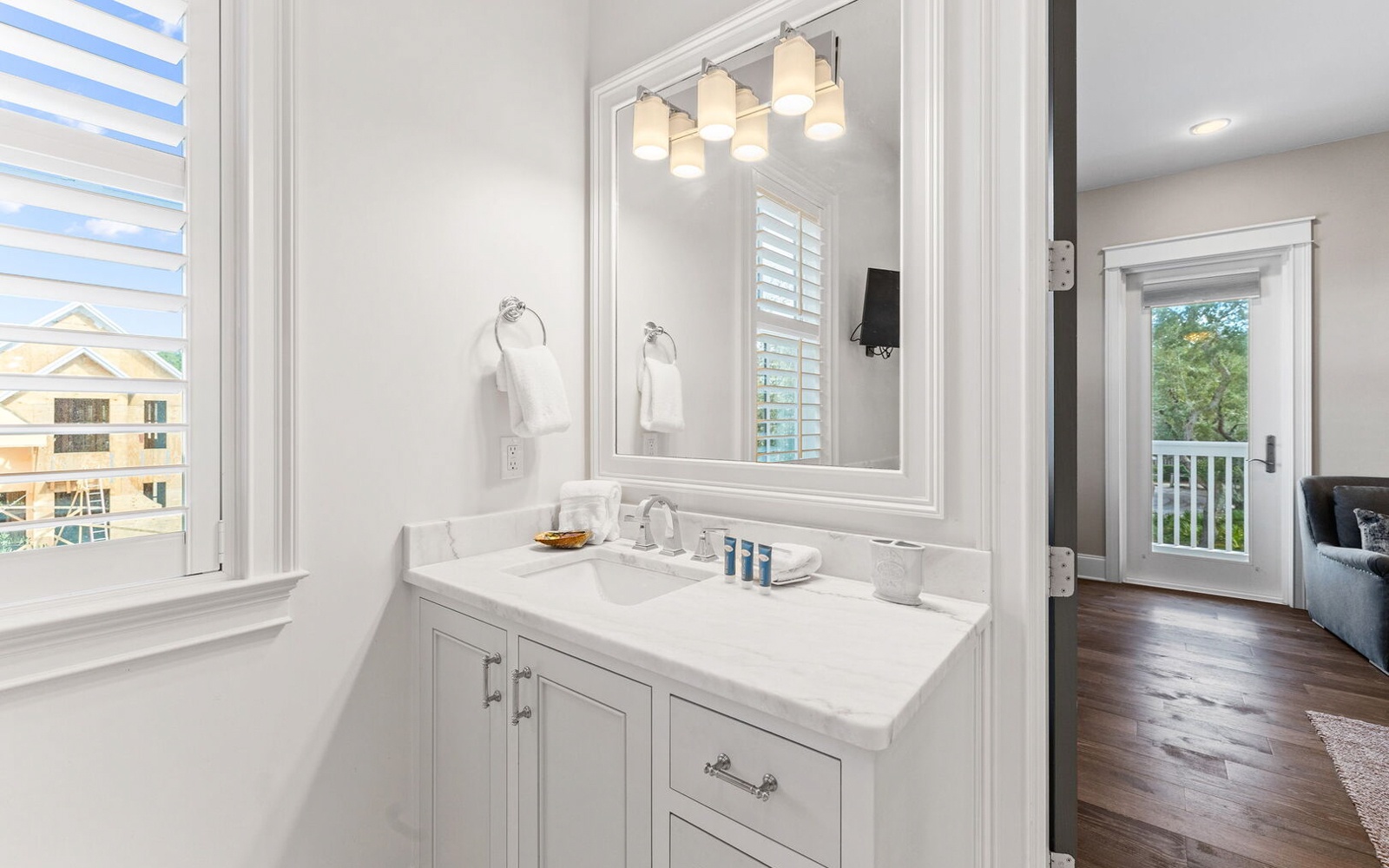 Pamper yourself in this elegant bathroom featuring marble countertops, perfect lighting, and fresh towels waiting for your arrival.