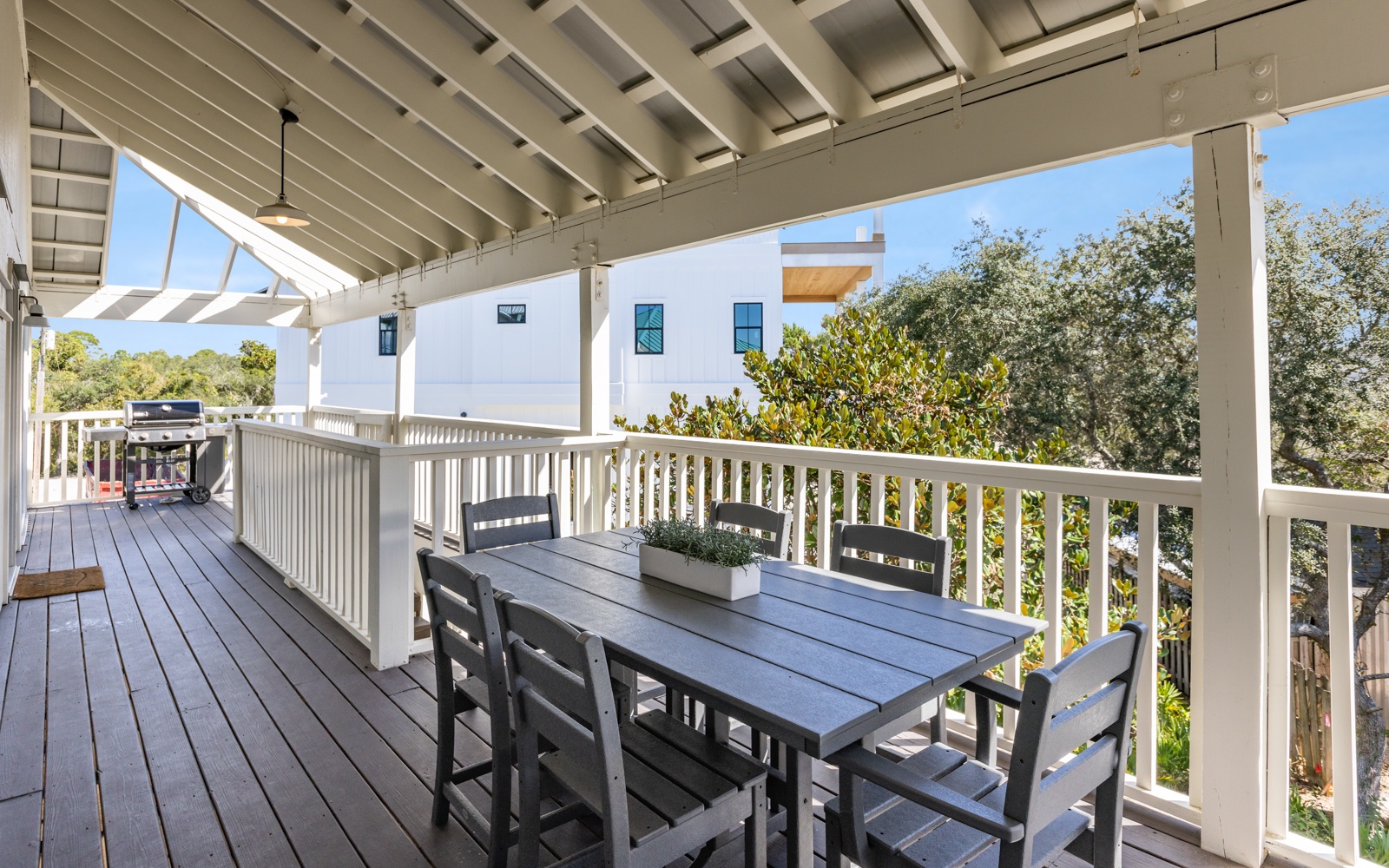 Enjoy outdoor dining on your covered deck with treetop views and modern seating for memorable meals.