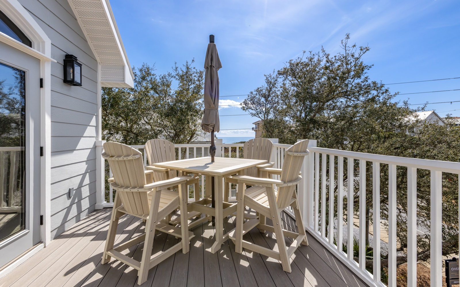 Sip your morning coffee on this sunny deck, surrounded by leafy trees and endless blue skies.