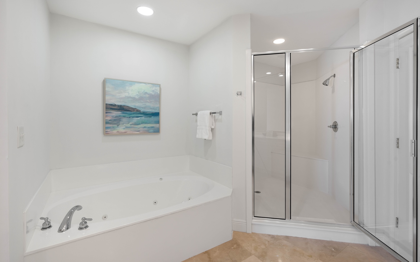 Unwind in your spa-like bathroom featuring a luxurious jetted tub and spacious glass shower, perfect for relaxing after your adventures.