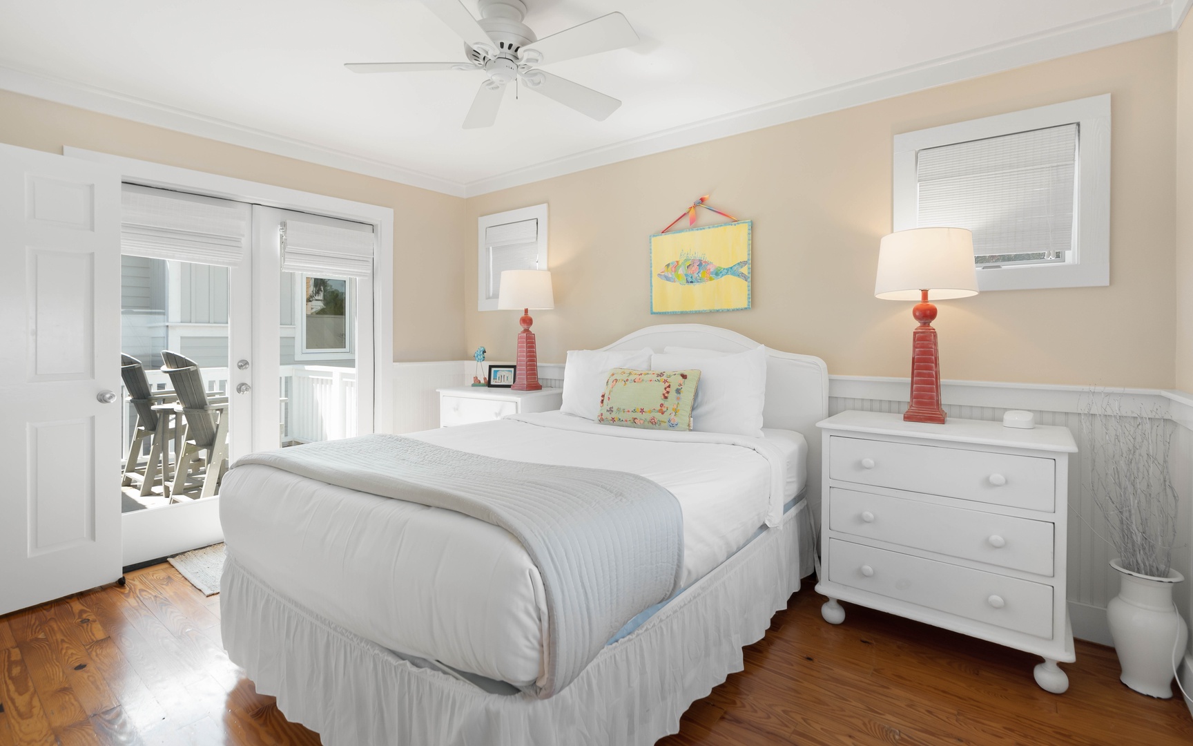 Wake up refreshed in your peaceful bedroom with coastal charm, complete with a ceiling fan and French doors opening to your private balcony.