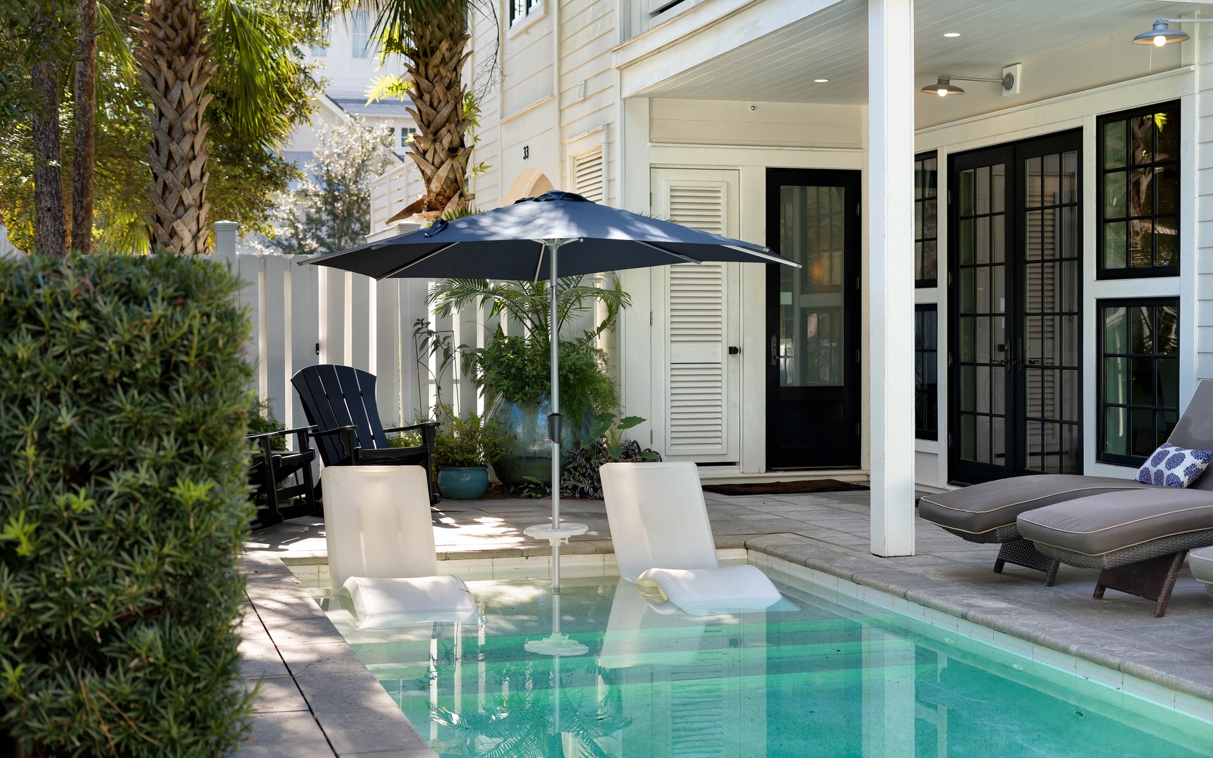 Your private pool awaits with comfortable loungers, poolside shade, and elegant outdoor living spaces.