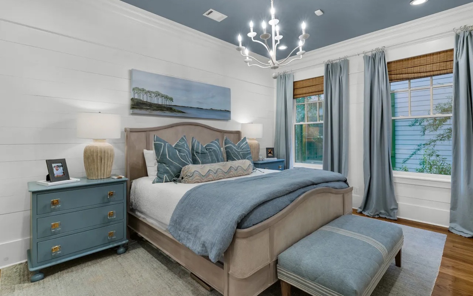 Drift off in your serene bedroom sanctuary, where coastal blues and warm wood create the perfect retreat for restful nights.