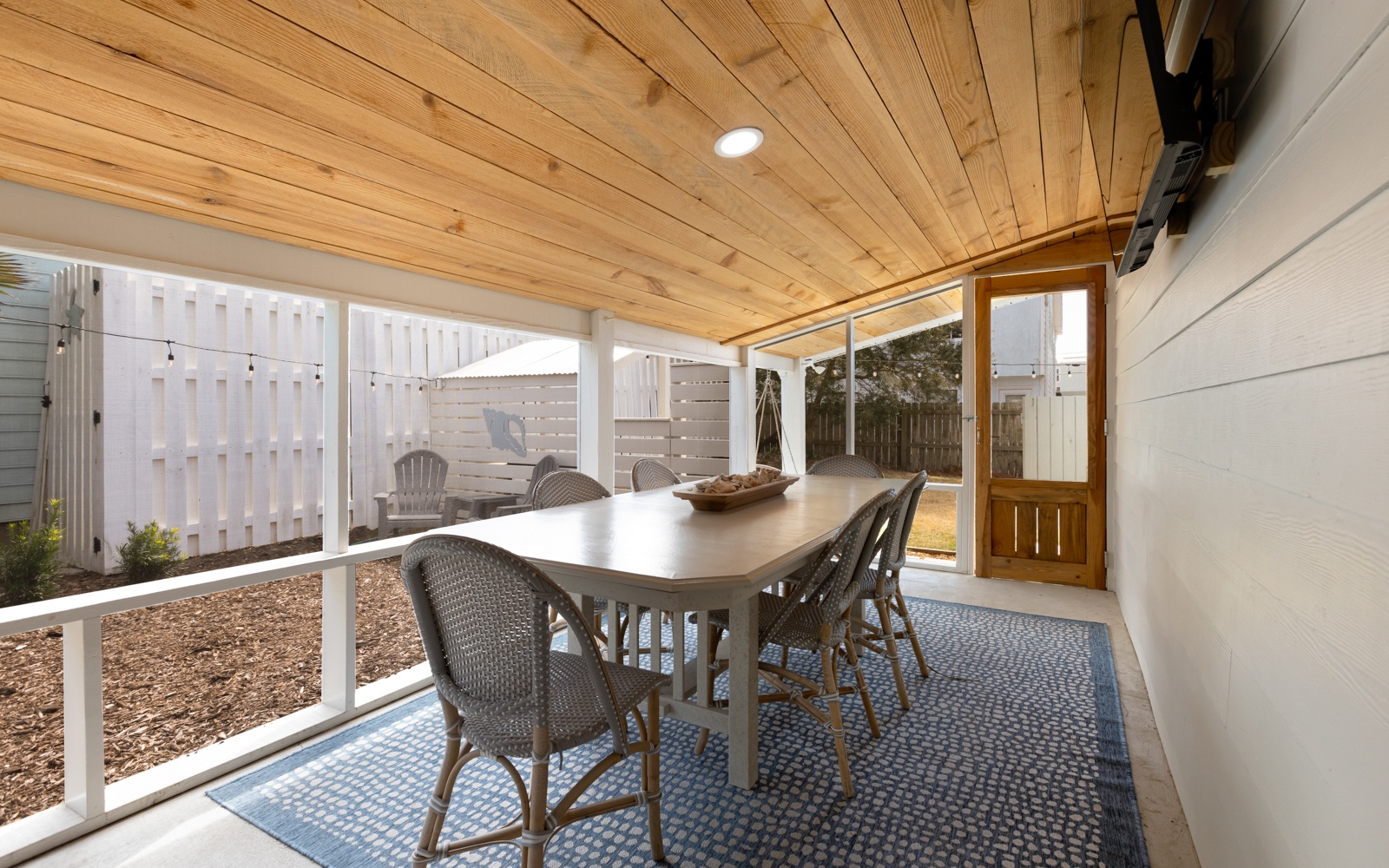 Your private covered patio invites you to dine al fresco beneath warm wood beams, creating the perfect backdrop for memorable meals outdoors.